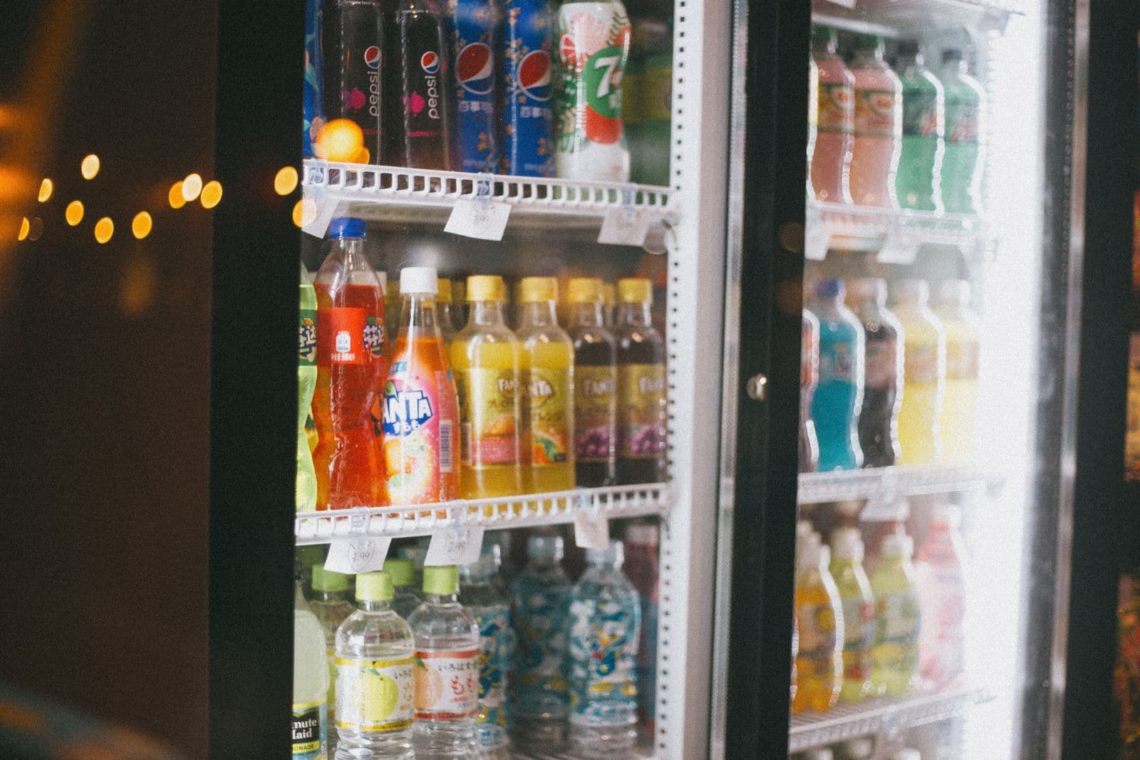 Store refrigerator stocked with bottled water — the most expensive way to drink it
